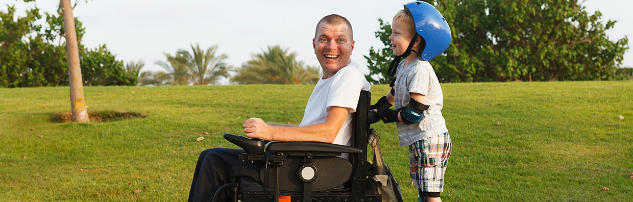 Man in wheelchair with rollerblading child